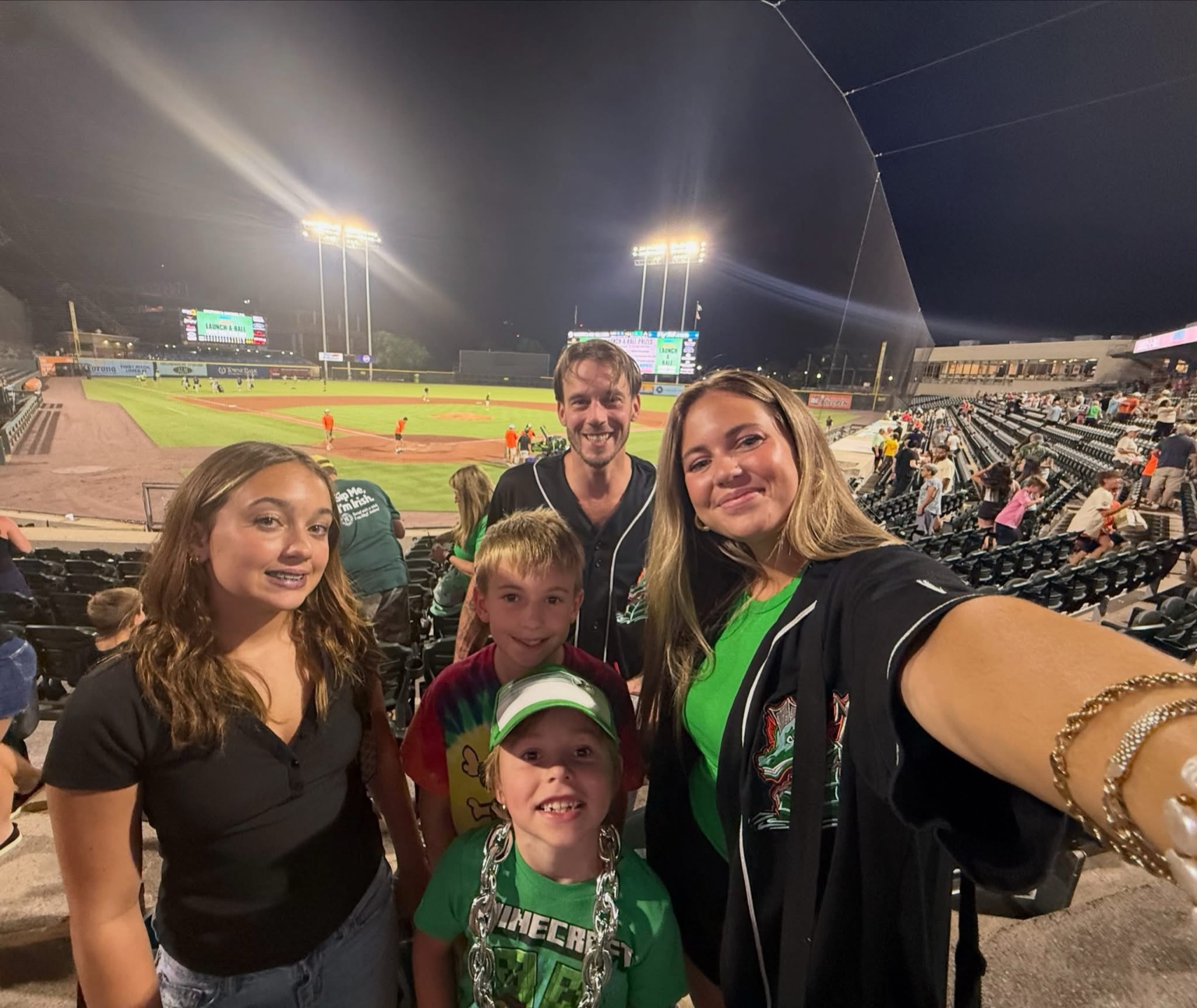 Brian and his family enjoying a baseball game together